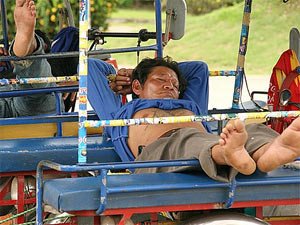 Local man sleeps in tuktuk Thailand