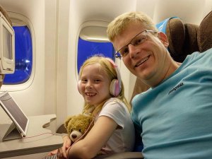 Father and daughter on plane