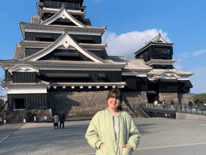 Woman standing infront of old Japanese building