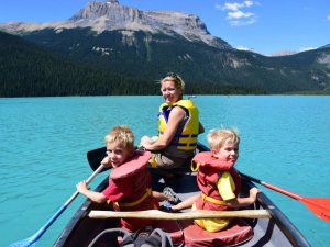 mother and children Kayaking on lake