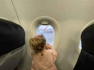 Child on plane looking out window