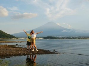 Two people standing in front of volcano