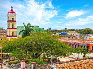 Elevated view of a colourful colonial town with a church, central park and brightly coloured buildings in Cuba