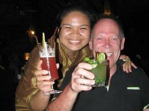 Vietnam tourist and local having drinks and smiling
