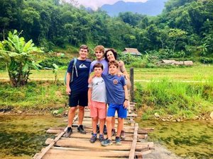 Family of five smiling in field