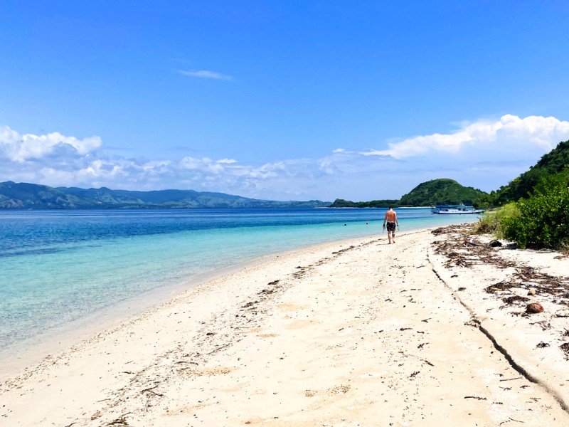 Man walking along beach
