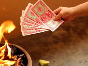 Person burning 'ghost money' in China