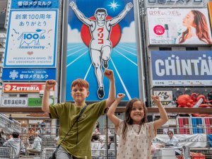 Kids in Japan posing with their arms up