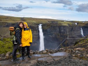 Family stood by waterfall Iceland Haifoss