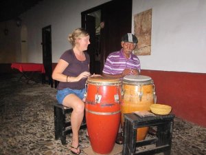 Ceri travel specialist playing drums with local in Trinidad
