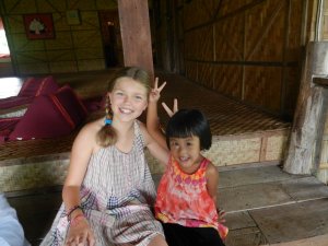 Tourist girl with young Thai girl in a homestay in Chiang Mai
