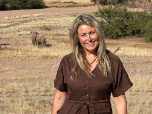 Gemma smiling in Namibia elephants behind