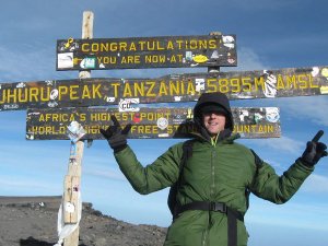 Person standing at Mt Kilimanjaro peak