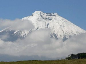 Snow capped volcano surrounded by clouds