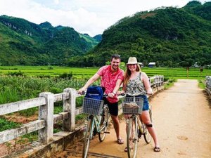 Couple on bicycles in rice fields