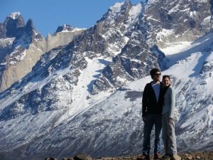 Couple stood next to mountains in Torres del Paine National Park