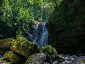 Waterfall with large rocks and trees