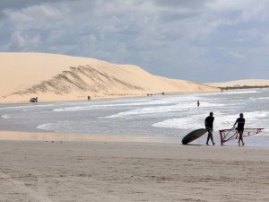 Windsurfers walking along the beach at Jericoacoara