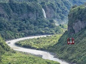 Cable car suspended over river bend