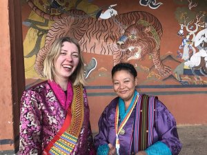 Tourist and local Bhutanese lady in traditional dress 