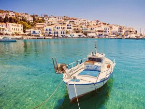 Fishing boat in water with town in background