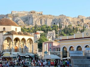 Greek town with ruins at top of hill in background