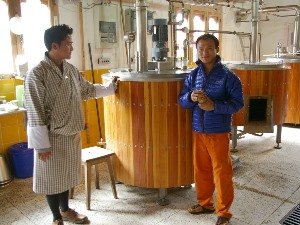 Two men in a cheese factory