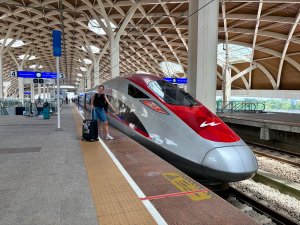 Child smiling as bullet train goes by