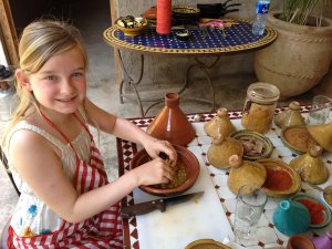 Girl with hands in bowl during cooking class