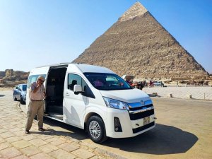 driver standing by minibus