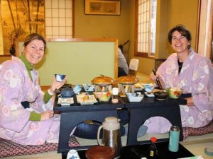 Two people sitting on floor eating food