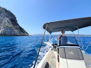 Person driving a boat on the sea