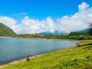 Lake surrounded by grass and hills