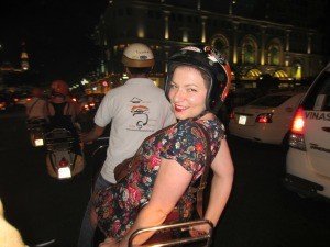 Vietnam Rickshaw staff riding a motorbike
