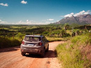 Car driving on dusty road