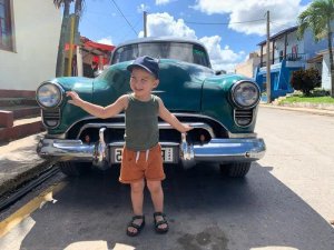 Child by car in Cuba