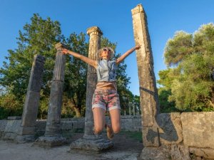 Greece Olympia ruins woman jumping