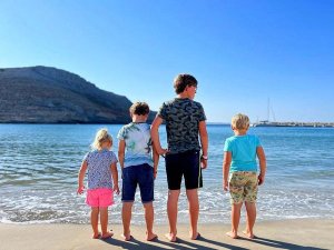 family on beach in greece