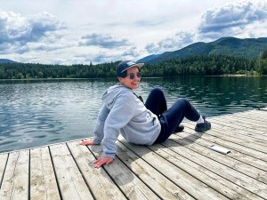 Ella sat on jetty by the lake
