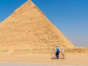 family in front of pyramid