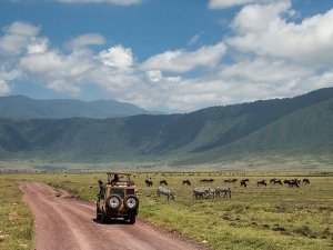 Jeep driving along road near Ngorongoro Crater