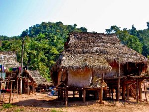 Thatched roof home on stilts in Northern Thailand