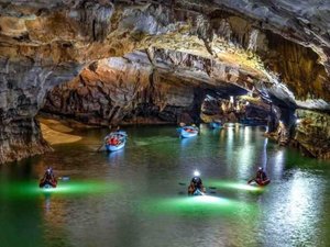 Several boats gliding inside of a cave