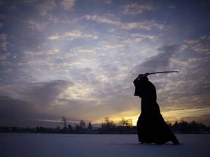 Silhouette of man holding sword