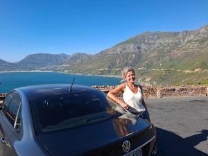 Woman leaning against car in South Africa
