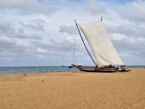 traditional sailboat on sand Negombo beach