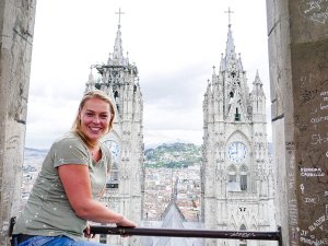 Woman smiling with view of church tower