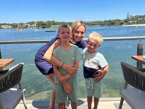 Emma with kids next to water