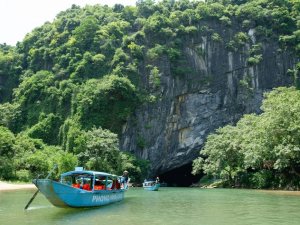 Boats floating near cave entrance