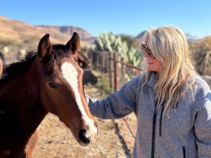 Gemma stroking horse in Namibia